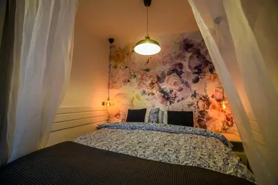 a bedroom with a bed with a painting on the wall at Panorama Central Apartments in Belgrade