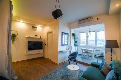 a living room with a couch and a table at Panorama Central Apartments in Belgrade