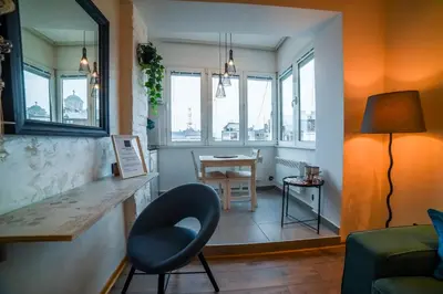 a living room with a chair and a table at Panorama Central Apartments in Belgrade