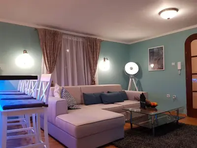 a living room with a couch and a table at Victory Dedinje in Belgrade