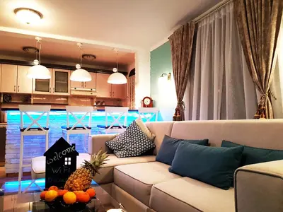 a living room with a couch and a kitchen at Victory Dedinje in Belgrade