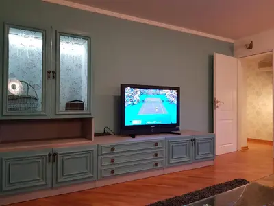 a living room with a television on a dresser at Victory Dedinje in Belgrade