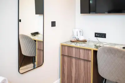 a kitchen with a counter and two chairs in a room at Hotel Bohemian Garni - Skadarlija in Belgrade