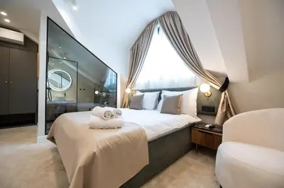 a bedroom with a large bed with towels on it at Hotel Bohemian Garni - Skadarlija in Belgrade