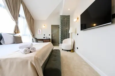 a bedroom with a bed with towels on it at Hotel Bohemian Garni - Skadarlija in Belgrade