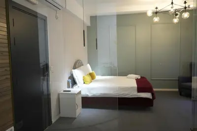 a bedroom with a bed with yellow pillows on it at Hotel Bohemian Garni - Skadarlija in Belgrade