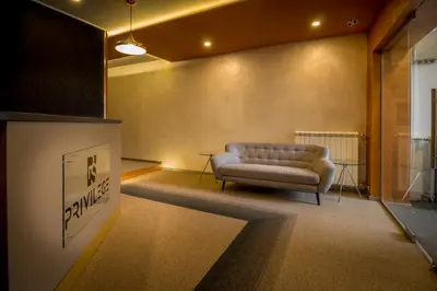 a living room with a couch in a room at Privilege Suites by Central Park in Belgrade