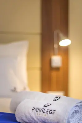 a towel sitting on top of a bed at Privilege Suites by Central Park in Belgrade