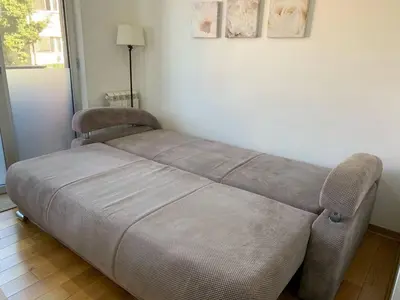 a bed in the corner of a room at Lazic Apartment in Belgrade