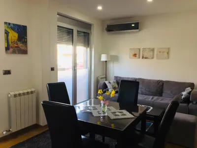 a living room with a table and a couch at Lazic Apartment in Belgrade
