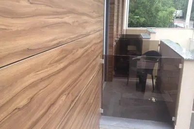 a wooden counter top with a desk and a window at Lazic Apartment in Belgrade