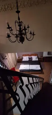 a dining room with a table and a chandelier at Apartment Danubius in Belgrade