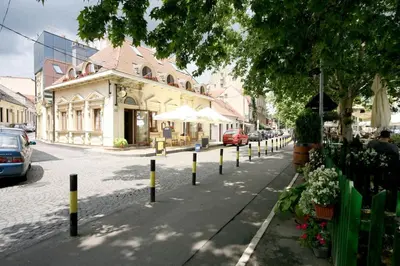 a street with yellow and black poles on the side of the road at Apartment Danubius in Belgrade