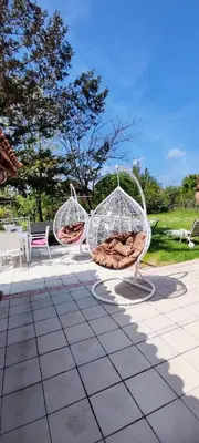 two white chairs sitting on top of a patio at Maslina Rooms in Smederevo