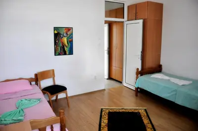 a room with two beds and a fireplace in it at Rooms Karadjordje in Belgrade