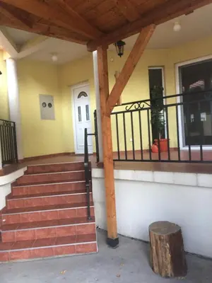 a porch of a house with stairs and a door at Aleksandar Apartment in Pančevo