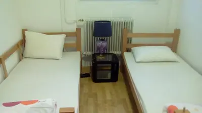 a room with two beds and a lamp in it at Hostel Jellostone in Belgrade