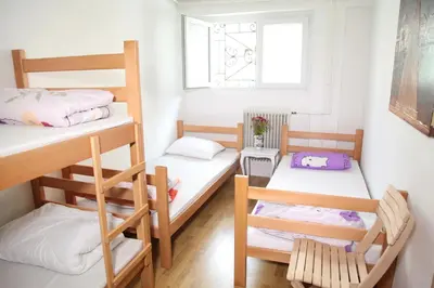 a room with two bunk beds and a window at Hostel Jellostone in Belgrade