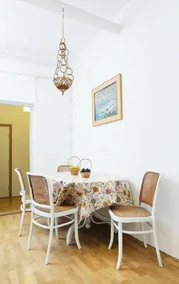 a dining room table with chairs and a table and a chandelier at Hostel Jellostone in Belgrade