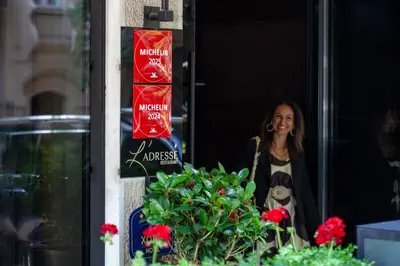 a woman walking out of a building with flowers at SAINT TEN Boutique Hotel, Small Luxury Hotels in Belgrade