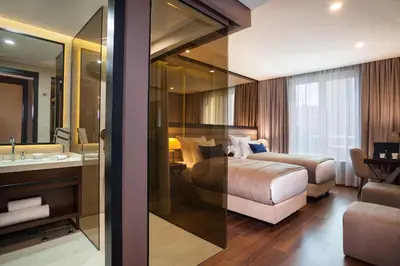 a hotel room with a bed and a bathroom at SAINT TEN Boutique Hotel, Small Luxury Hotels in Belgrade