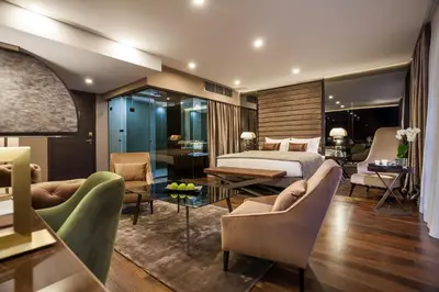 a hotel room with a bed and a table and chairs at SAINT TEN Boutique Hotel, Small Luxury Hotels in Belgrade