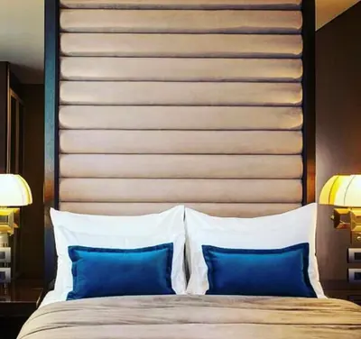 a large bed with blue pillows in a bedroom at SAINT TEN Boutique Hotel, Small Luxury Hotels in Belgrade