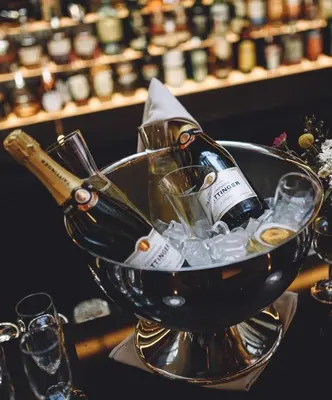 a bottle of champagne and glasses in a ice bucket at SAINT TEN Boutique Hotel, Small Luxury Hotels in Belgrade