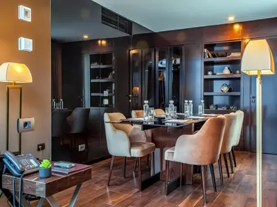 a restaurant with a bar with chairs and a table at SAINT TEN Boutique Hotel, Small Luxury Hotels in Belgrade