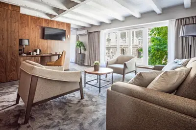 a living room with a couch and chairs and a table at Nomad Luxury Suites in Belgrade