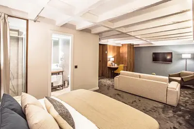 a hotel room with a bed and a couch at Nomad Luxury Suites in Belgrade