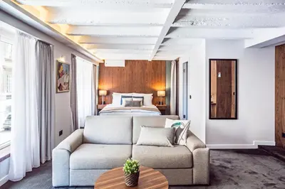 a living room with a couch and a bed at Nomad Luxury Suites in Belgrade