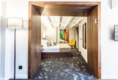 a bedroom with a bed with a large wooden wall at Nomad Luxury Suites in Belgrade