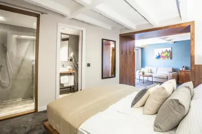 a bedroom with a large bed and a bathroom at Nomad Luxury Suites in Belgrade