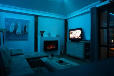 a blue living room with a couch and a television at Blue Danube Apartment in Belgrade