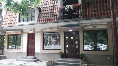 a building with a bunch of windows and a balcony at Blue Danube Apartment in Belgrade
