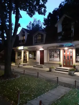 a white house with a red door at night at Blue Danube Apartment in Belgrade
