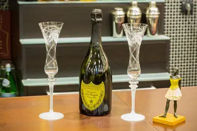 a bottle of wine and two wine glasses on a table at Hotel Sterling Garni in Belgrade