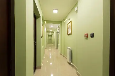 a hallway of a hospital with green walls at Hotel Sterling Garni in Belgrade