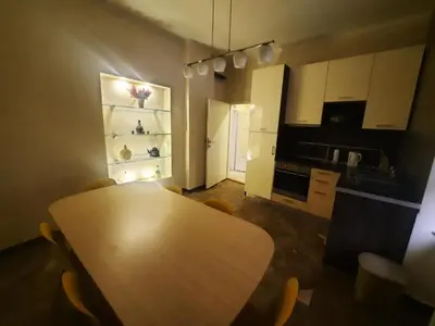 a kitchen with a wooden table and chairs in a room at Authentic Belgrade Centre Apartment #5, Four bedrooms, One Full Bathroom, One Toilet in Belgrade