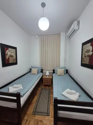 a room with two twin beds in a room at Authentic Belgrade Centre Apartment #5, Four bedrooms, One Full Bathroom, One Toilet in Belgrade
