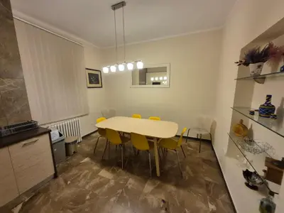 a kitchen and dining room with a table and yellow chairs at Authentic Belgrade Centre Apartment #5, Four bedrooms, One Full Bathroom, One Toilet in Belgrade