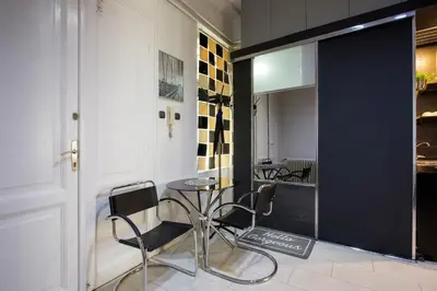 a dining room with a table and chairs in a room at Princ Apartment in Belgrade