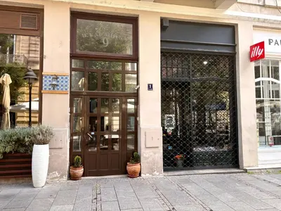 a store front with a brown door on a street at Princ Apartment in Belgrade