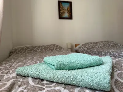 a pile of towels sitting on top of a bed at Apartman Centar BB in Pančevo