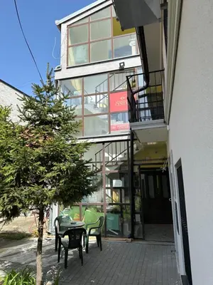 a building with chairs and a table on a patio at Apartman Centar BB in Pančevo