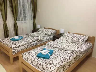 two beds in a room with towels on them at AMN Center Apartment in Belgrade