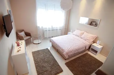 a small bedroom with a bed and a window at Savamala Lux Apartment in Belgrade