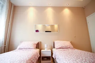 a bedroom with two beds and a mirror on the wall at Savamala Lux Apartment in Belgrade