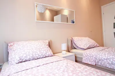 a bedroom with two beds and a mirror at Savamala Lux Apartment in Belgrade